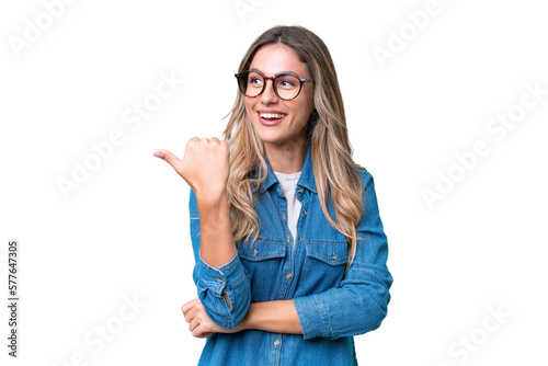 Young Uruguayan woman over isolated background pointing to the side to present a product