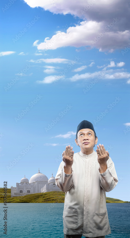 Asian Muslim man raised his hands and prayed Asian Muslim man raised his hands and prayed