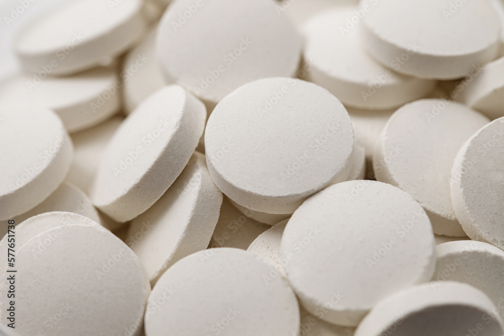 Tablets round white medical, medicines many in bulk, selective focus