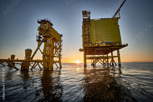 View of Offshore electrical distribution station for wind farms in the sunset at sea. photo