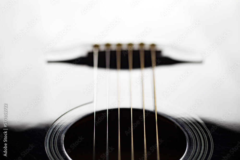Fototapeta premium Guitar black, six stringed plucked musical instrument, lower threshold, close-up selective focus