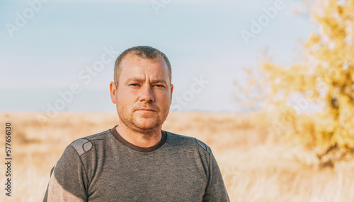 Friendly unshaven adult man outdoors portrait
