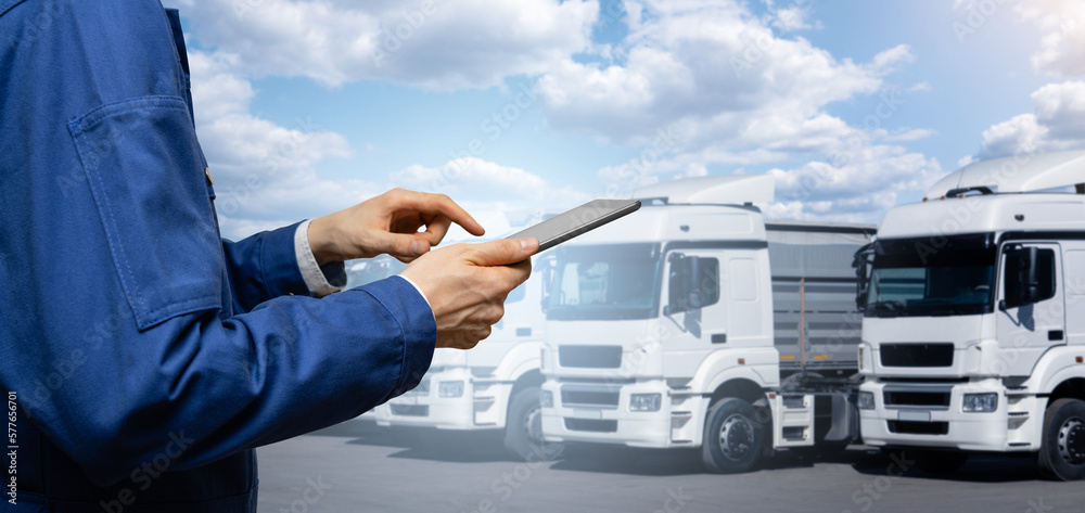 Manager with a digital tablet next to trucks. Fleet management Manager with a digital tablet next to trucks. Fleet management