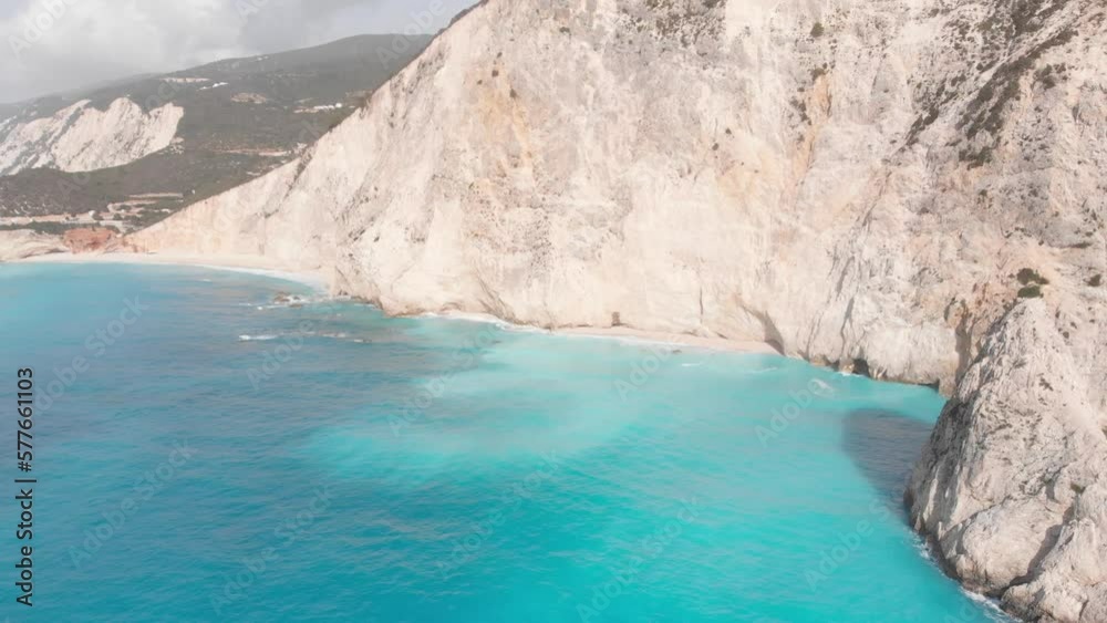 Aerial view of beautiful empty beach in Greece, no people. Dramatic coastline scenic bay rocky cliffs in the Ionian island, Port Katsiki, Lefkada. Blue turquoise waving sea. Aerial view of beautiful empty beach in Greece, no people. Dramatic coastline scenic bay rocky cliffs in the Ionian island, Port Katsiki, Lefkada. Blue turquoise waving sea.