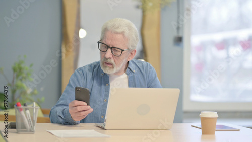 Old Man Reacting to Online Loss on Laptop