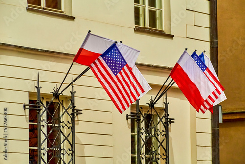 Flags of the USA and Poland hang outside on the house