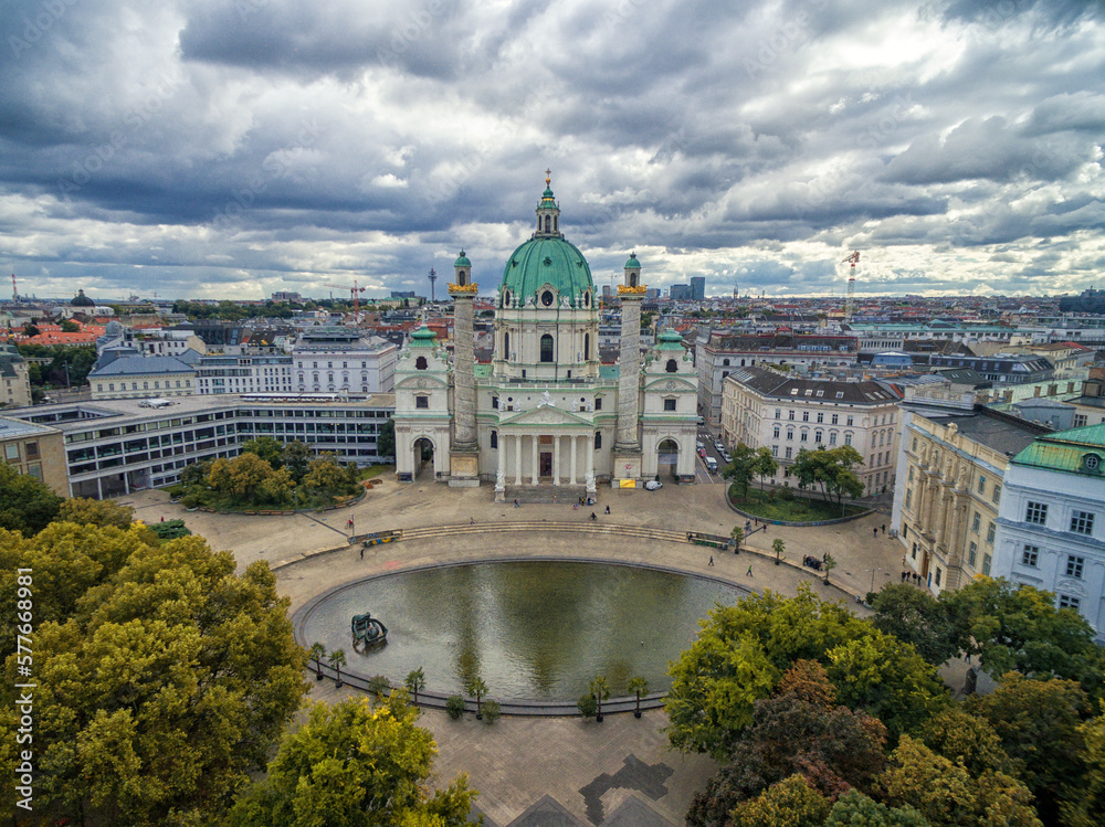 Vienna Karlskirche Church with Resselpark park and Cloudy Sky. Austria
