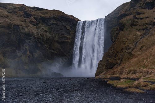 Skogafoss Waterfall In Iceland. Long Exposure Water Spray and Rocks.