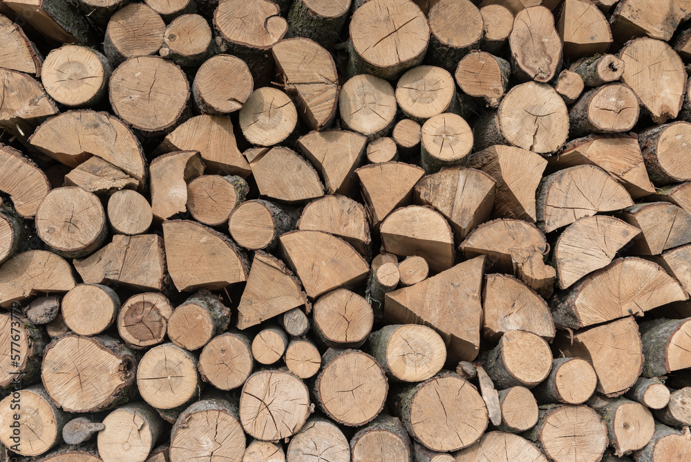 Firewood Outdoor, Brown Background. Dry Chopped Firewood logs in a pile Firewood Outdoor, Brown Background. Dry Chopped Firewood logs in a pile