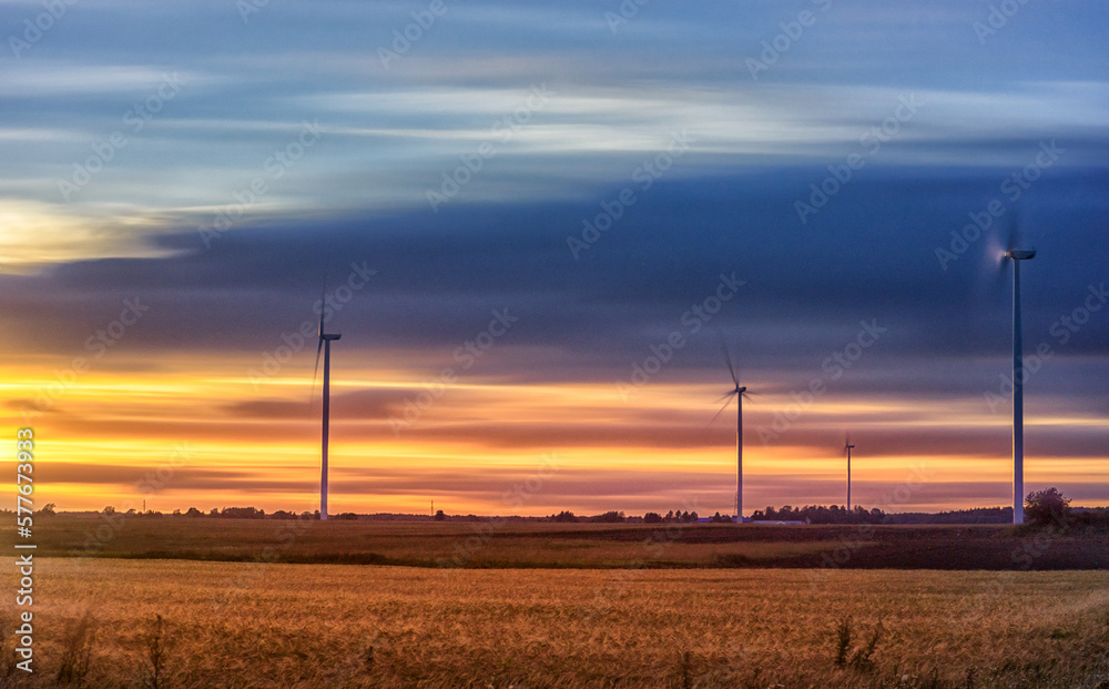 Windmill in Nature. Blurry Cloudy Sky. Long Exposure. Beautiful Nature. Sunset Light. Windmill in Nature. Blurry Cloudy Sky. Long Exposure. Beautiful Nature. Sunset Light.