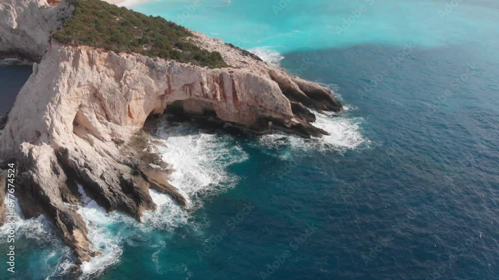 Aerial view of beautiful empty beach in Greece, no people. Dramatic coastline scenic bay rocky cliffs in the Ionian island, Port Katsiki, Lefkada. Blue turquoise waving sea. Aerial view of beautiful empty beach in Greece, no people. Dramatic coastline scenic bay rocky cliffs in the Ionian island, Port Katsiki, Lefkada. Blue turquoise waving sea.