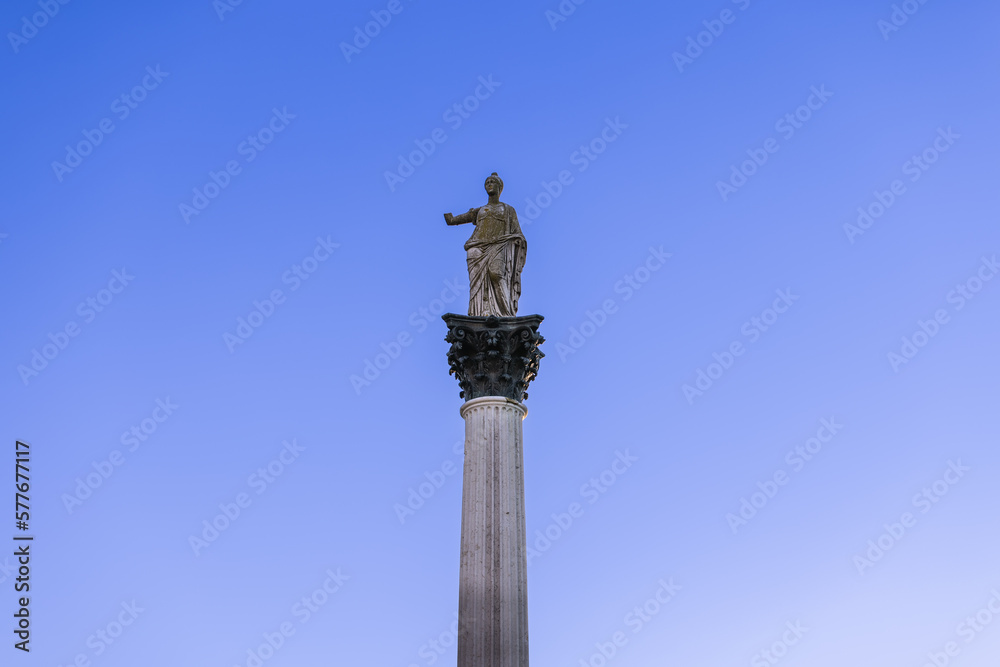 Statue of Minerva on the Colonna di Minerva and Galleria degli Antichi against the blue sky. Sabbioneta, Lombardy, Italy Statue of Minerva on the Colonna di Minerva and Galleria degli Antichi against the blue sky. Sabbioneta, Lombardy, Italy