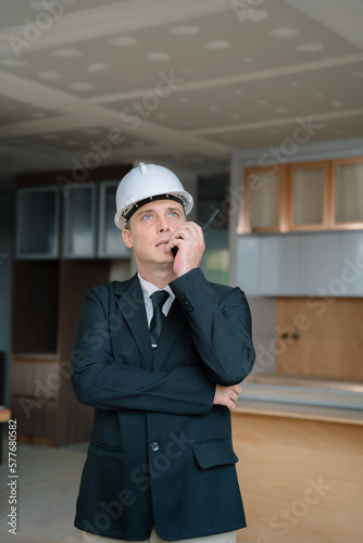 Engineers on building site checking plans.