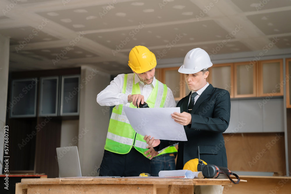 Architect caucasian man working with colleagues mixed race in the construction site. engineer architect wearing safety helmet meeting at contruction site. worker Architect caucasian man working with colleagues mixed race in the construction site. engineer architect wearing safety helmet meeting at contruction site. worker