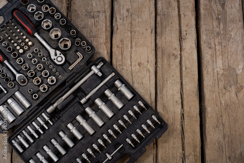 Tool box on the wood backdrop. Set of wrenches and bits. Tool box on the wood backdrop. Set of wrenches and bits.