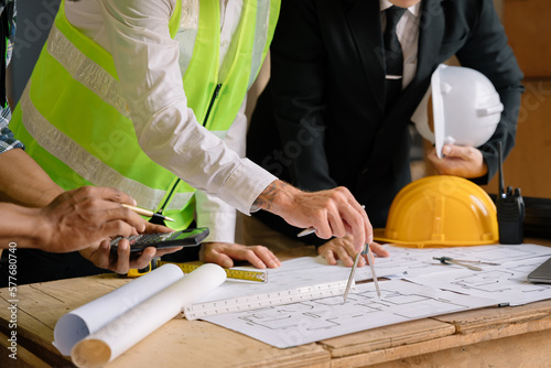 Architect man brainstorm collaboration ideas pointing blueprints at construction site inspection.