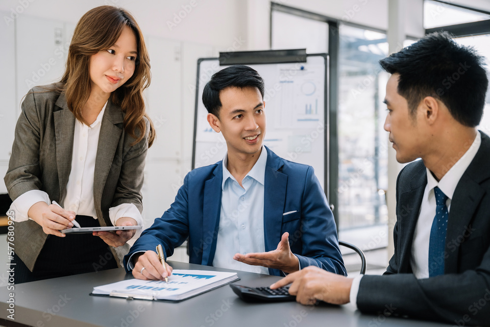 Fototapeta premium Group of Young Asian business team creative businesspeople coworker in office. Meeting Presentation for analysis graph company financial. People Work in Business Office.