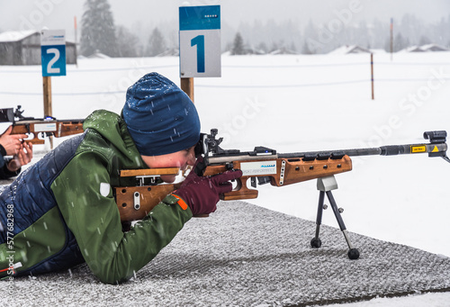 Papier peint Boy doing shooting practice with a laser rifle for biathlon training in winter
