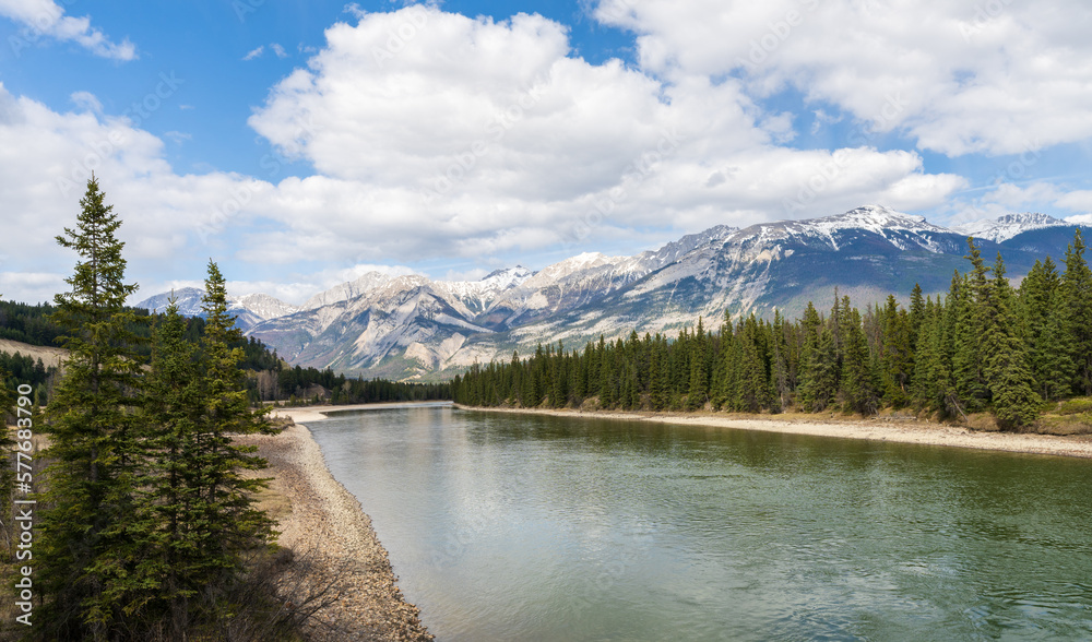 Canadian Rockies Jasper National Park stunning nature scenery. Athabasca River, snow capped mountains in summer. Alberta, Canada. Canadian Rockies Jasper National Park stunning nature scenery. Athabasca River, snow capped mountains in summer. Alberta, Canada.