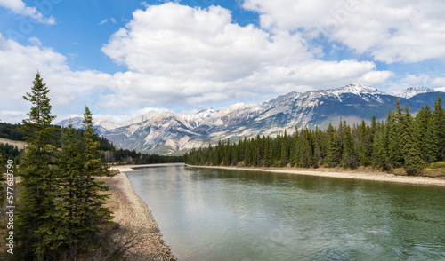 Canadian Rockies Jasper National Park stunning nature scenery. Athabasca River, snow capped mountains in summer. Alberta, Canada.