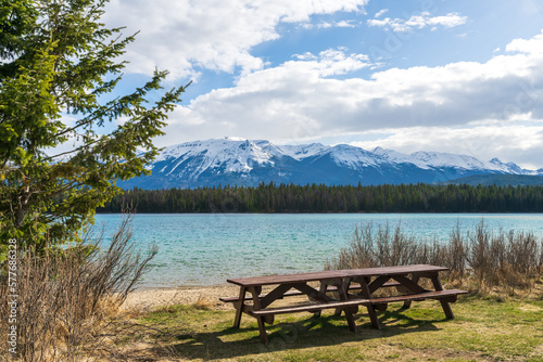 Lake Annette lake shore beach and bench, Jasper National Park stunning nature scenery in summer time. Landscape of Canadian Rockies, Alberta, Canada.
