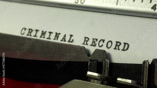 Crime and law and order. Using an old manual typewriter to type up a Criminal Record. photo