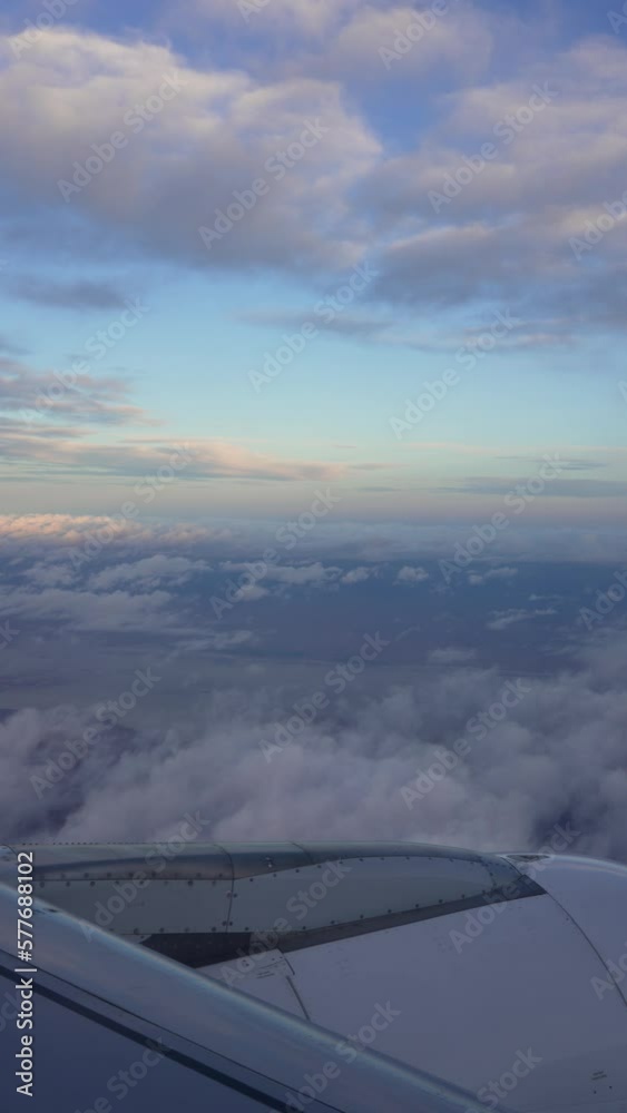 view from the porthole of commercial plane to the clouds and horizon over the turbine in the Chilean Patagonia