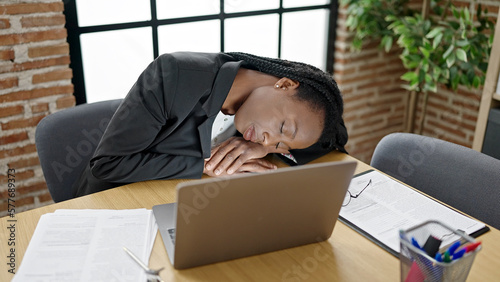 African american woman business worker sleeping on table at office