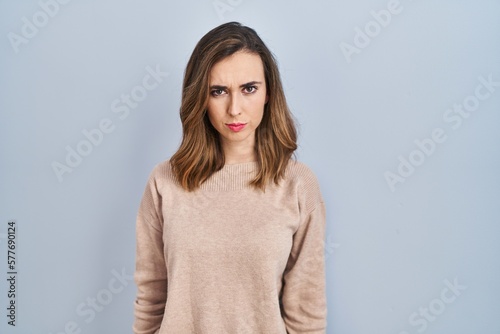 Young woman standing over isolated background skeptic and nervous, frowning upset because of problem. negative person. © Krakenimages.com