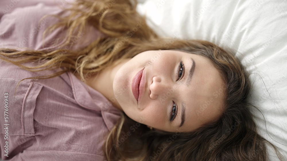 Young beautiful hispanic woman smiling confident lying on bed at bedroom Young beautiful hispanic woman smiling confident lying on bed at bedroom