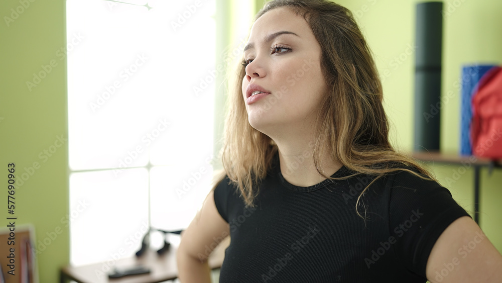 Young beautiful hispanic woman standing with relaxed expression at sport center