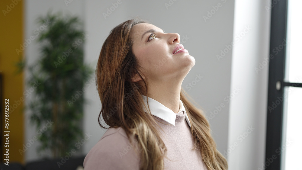 Young beautiful hispanic woman smiling confident looking up at home