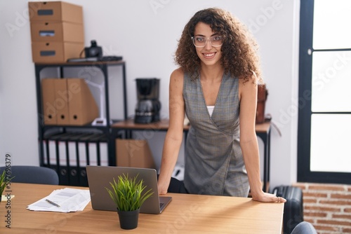 Young beautiful hispanic woman business worker smiling confident standing at office © Krakenimages.com