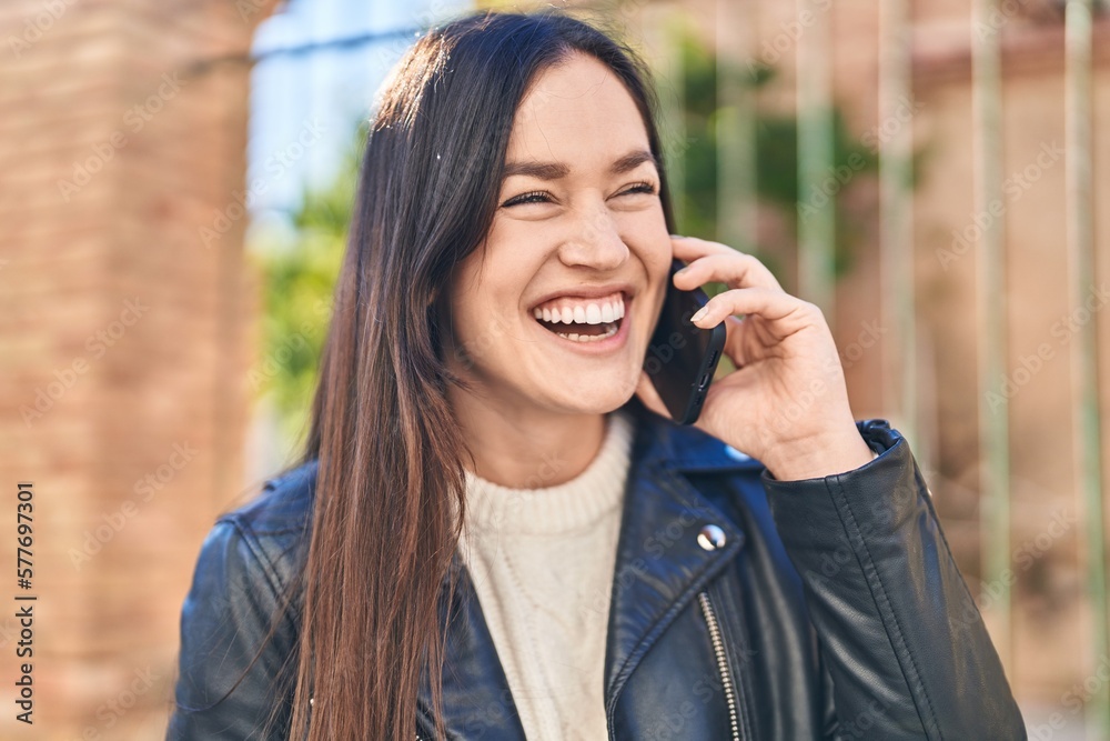 Young woman smiling confident talking on the smartphone at street Young woman smiling confident talking on the smartphone at street