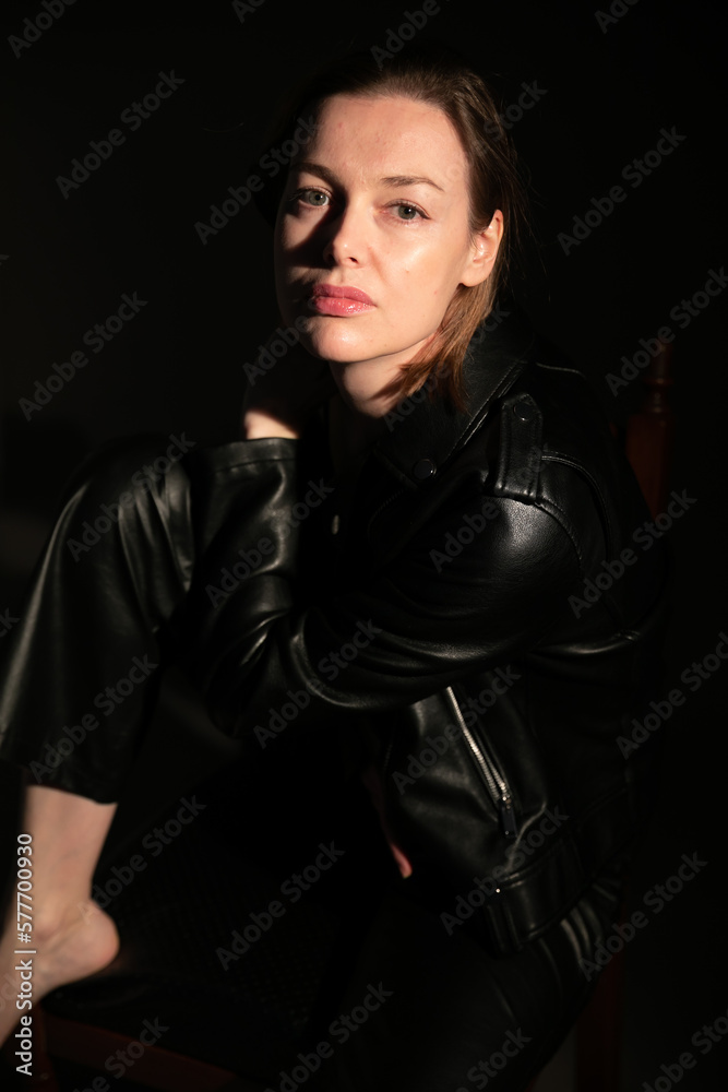 portrait of a woman in leather black clothes in the dark portrait of a woman in leather black clothes in the dark