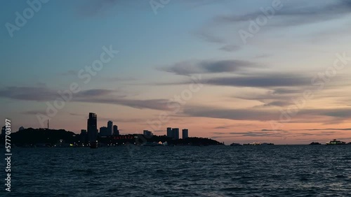 Timelapse of the colorful sunset view at the island beach with ocean waves and clouds in the background with 4K resolution.