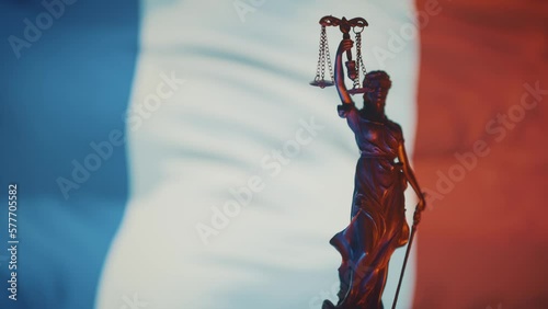 The Statue of Justice - lady justice, Justitia the Roman goddess of Justice in front of French flag