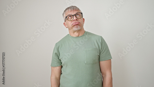 Middle age grey-haired man wearing glasses looking upset over isolated white background
