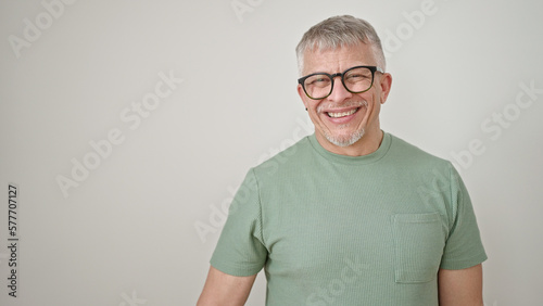 Middle age grey-haired man smiling confident wearing glasses over isolated white background