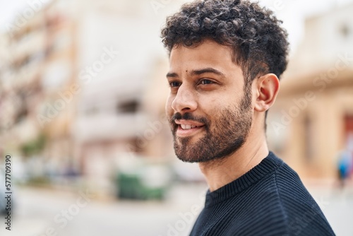 Young arab man smiling confident standing at street