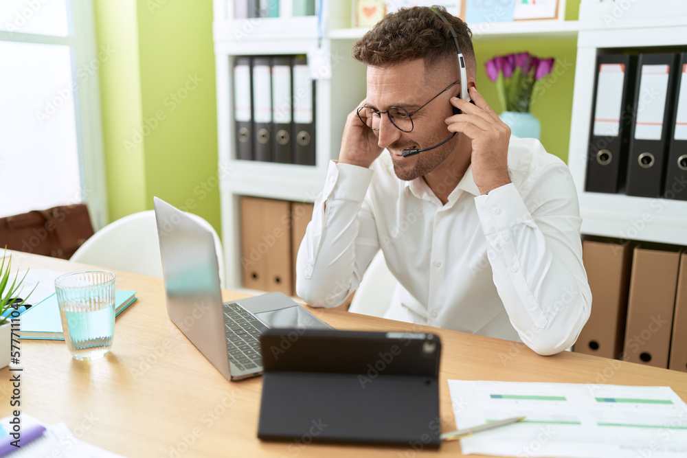 Young hispanic man call center agent working at office Young hispanic man call center agent working at office