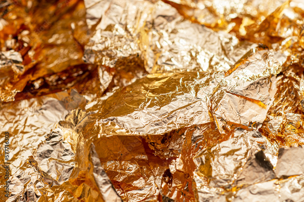 Gold foil flakes. Art and craft supply. Decorative material. Metallic background Gold foil flakes. Art and craft supply. Decorative material. Metallic background