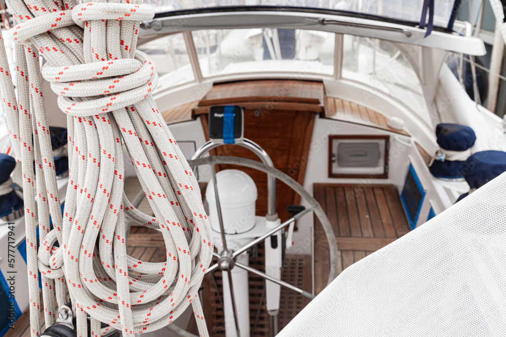 Cabin of a sailing yacht with a steering wheel, rollers for attaching