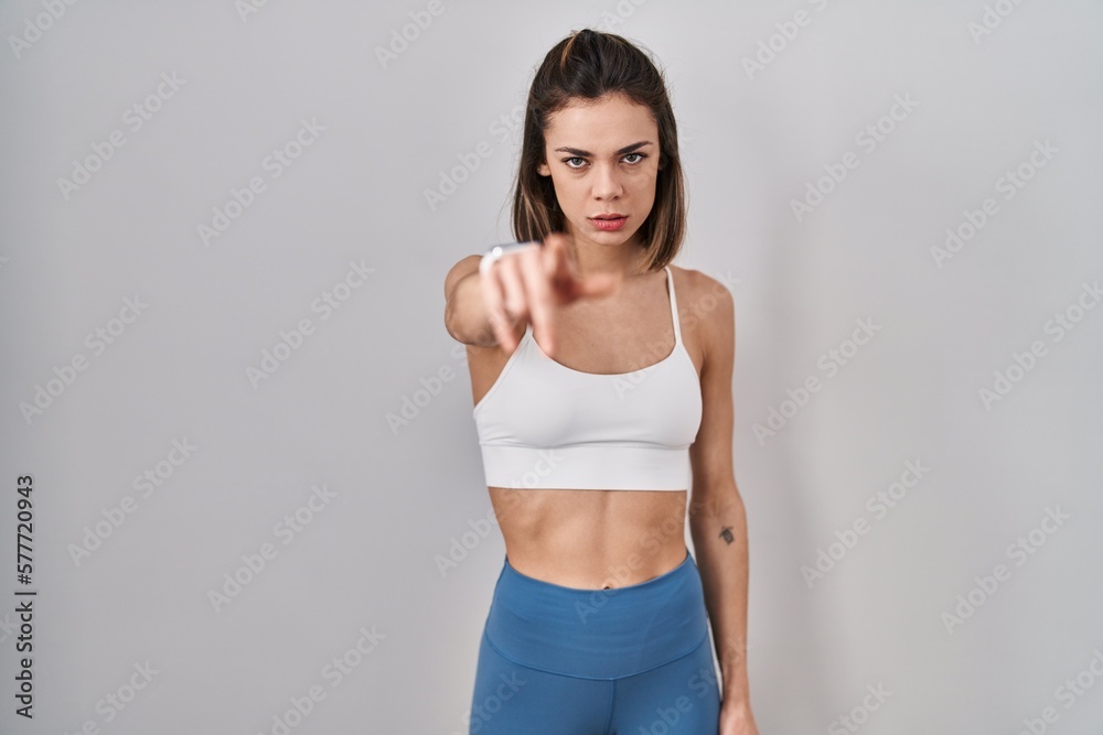Hispanic woman wearing sportswear over isolated background pointing displeased and frustrated to the camera, angry and furious with you Hispanic woman wearing sportswear over isolated background pointing displeased and frustrated to the camera, angry and furious with you