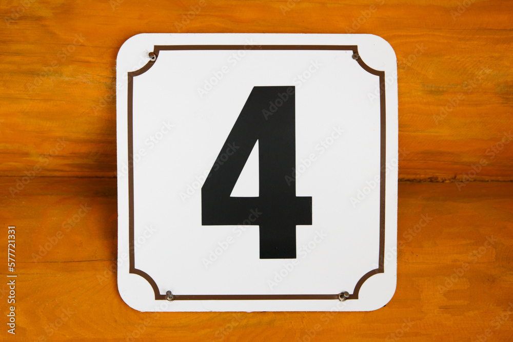 plaque with number four on wall of house plaque with number four on wall of house