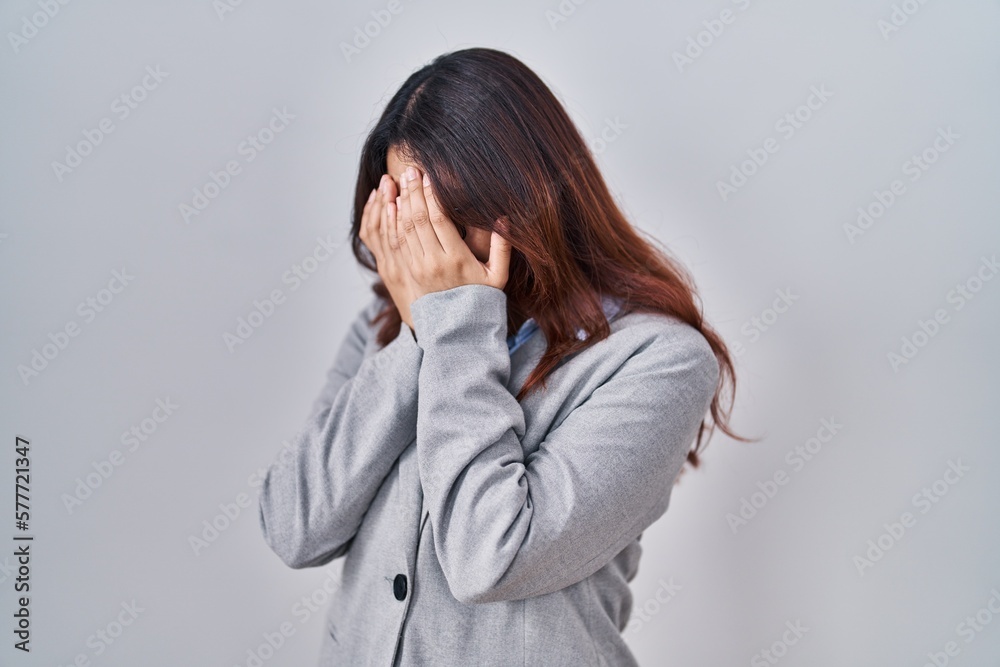 Hispanic young business woman wearing glasses with sad expression covering face with hands while crying. depression concept. Hispanic young business woman wearing glasses with sad expression covering face with hands while crying. depression concept.