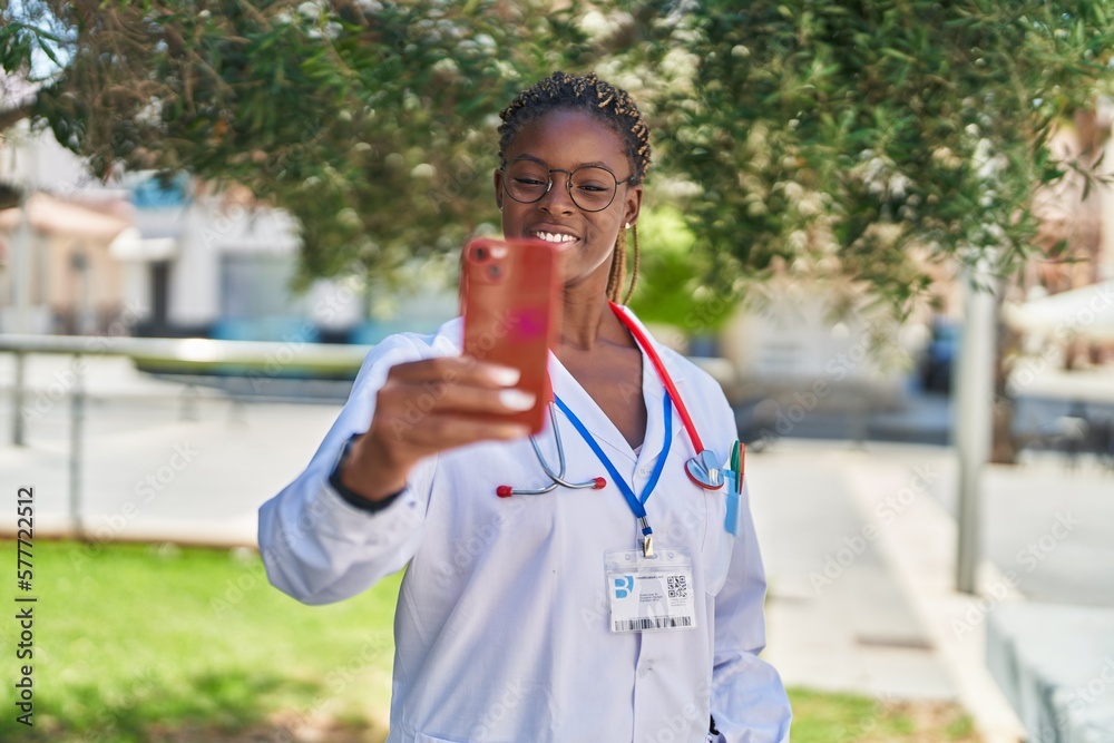 Fototapeta premium African american woman doctor smiling confident having video call at park