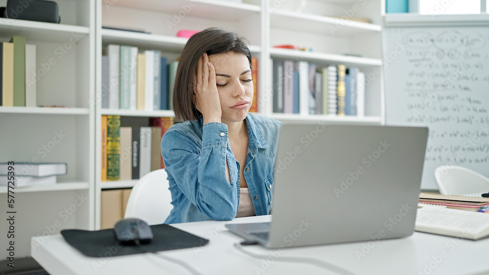 Young caucasian woman student tired studying at university classroom Young caucasian woman student tired studying at university classroom