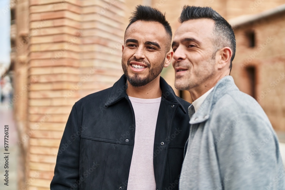 Two men couple smiling confident standing together at street Two men couple smiling confident standing together at street