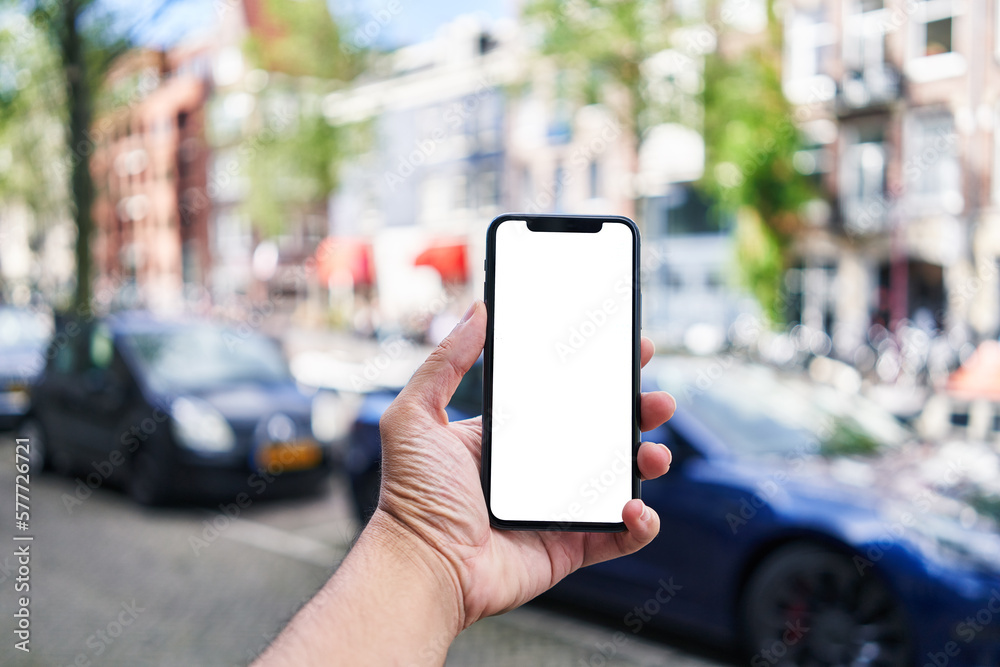 Man holding smartphone showing white blank screen at amsterdam Man holding smartphone showing white blank screen at amsterdam
